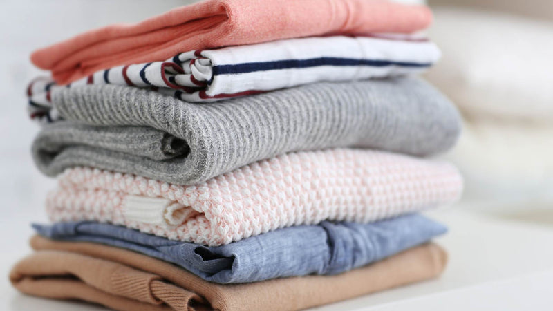 A bundle of clothes folded nicely—9 ways to naturally eliminate odor from clothes