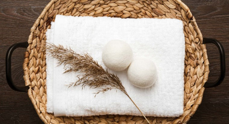 Two wool dryer balls on a white towel—Are wool dryer balls worth it?