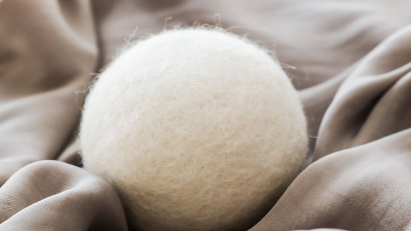 Wool dryer ball on a grey fabric—Do wool dryer balls reduce wrinkles?